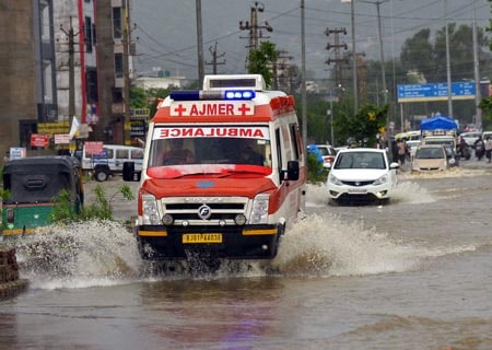 <p>Ajmer: An ambulance wades through a water-logged street during rains, in Ajmer on Aug 17, 2019. </p>
