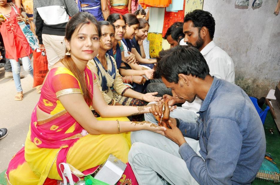 <p>Women Mehndi on their hands for Teej Vrat. Women keep 24 hour fasting without water for well being of their husbands.</p>
