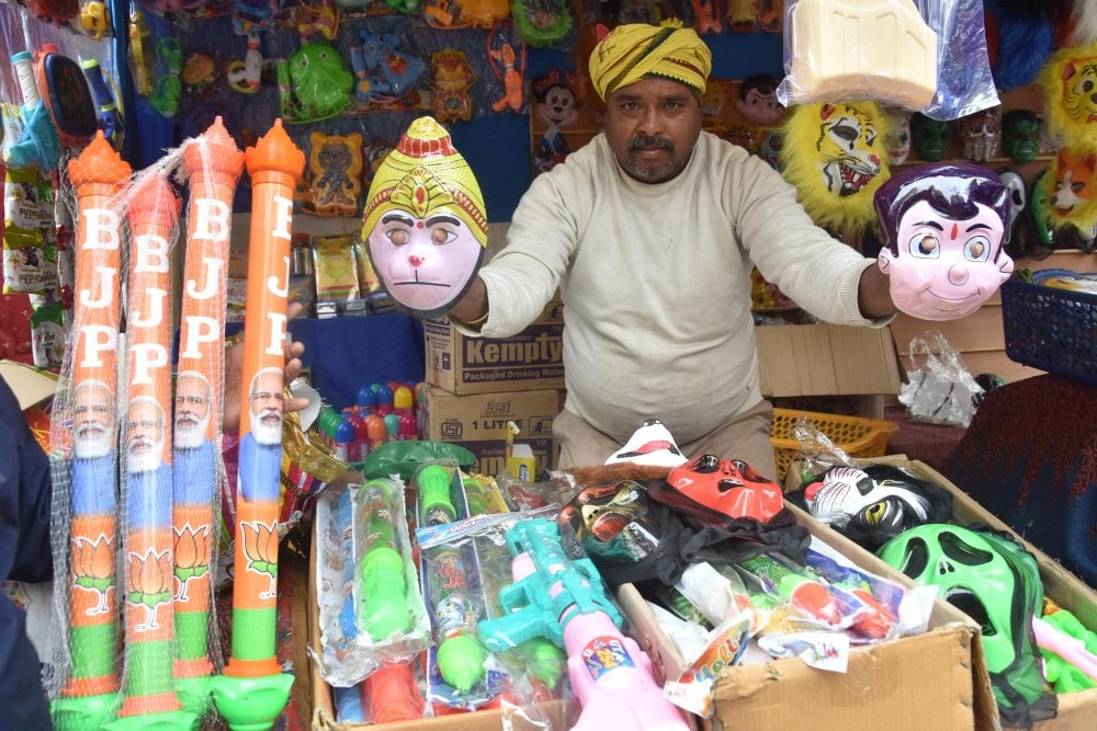 <p>A man sells water guns depicting the picture of Prime Minister Narendra Modi along with Lord Hanuman and Chota Bheem ahead of Festival of Colours ‘Holi’ in Ranchi, Jharkhand on…