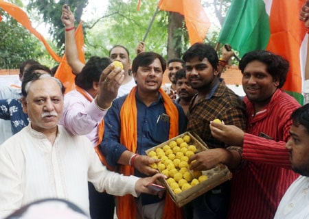 <p>New Delhi: People exchange sweets as they celebrate the Centre's decision to scrap Article 370 of the Constitution and to give Jammu and Kashmir a Union Territory status; in…